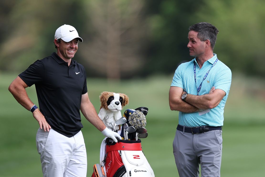 McIlroy chats with his manager Sean O'Flaherty during a practice round ahead of the tournament.