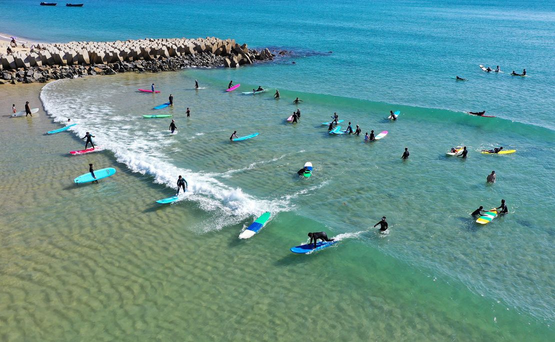 This aerial photo shows tourists going surfing at Riyue Bay.