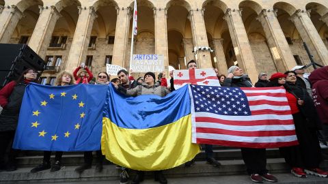 People hold flags of the Europan Union, Ukraine and the US during a demonstration outside Georgia's Parliament in Tbilisi on March 8.