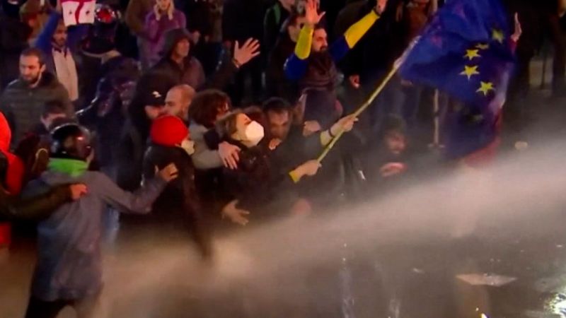 Video: Georgian protesters shield woman waving EU flag amid clash with police  | CNN