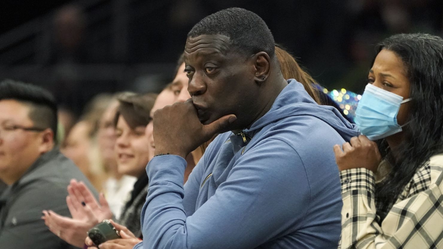 Former Seattle SuperSonics forward Shawn Kemp, center, attends a WNBA basketball game between the Seattle Storm and the Chicago Sky on May 18, 2022, in Seattle.
