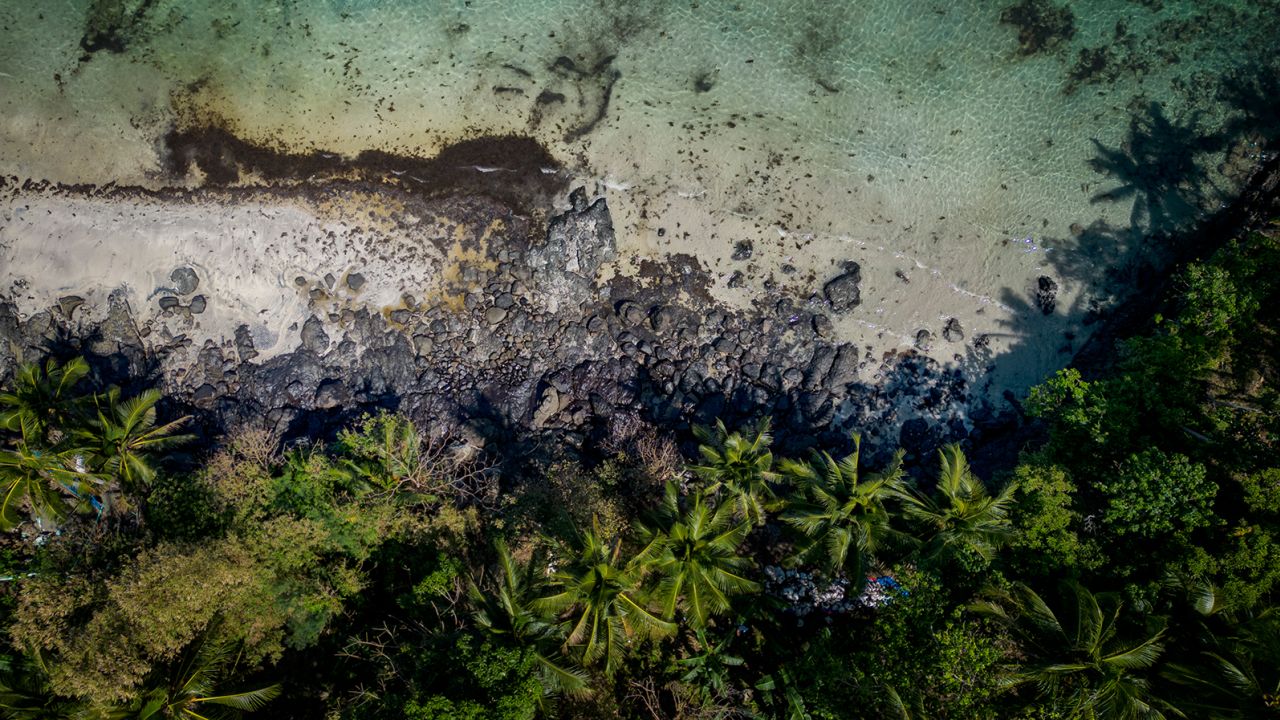 An oil slick from the sunken tanker MT Princess Empress along a shoreline on March 8, 2023, in Pola, Oriental Mindoro, Philippines. 