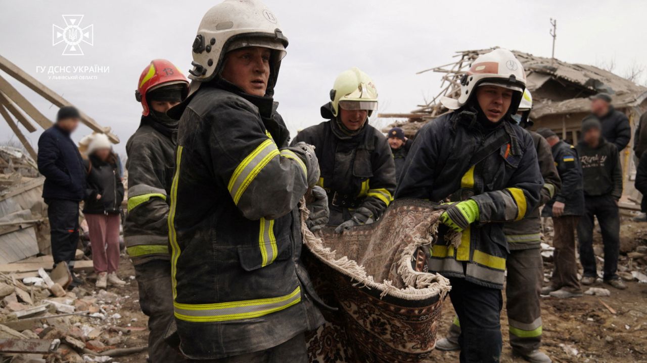 Rescuers carry a body after Russian strikes hit Lviv on Thursday.