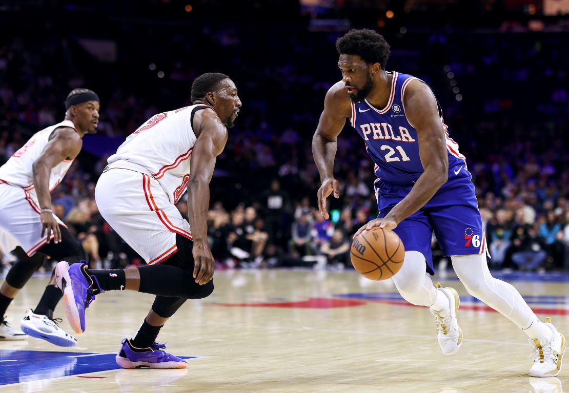 Joel Embiid of the Philadelphia 76ers drives past Bam Adebayo of the Miami Heat at Wells Fargo Center on February 27, 2023, in Philadelphia.