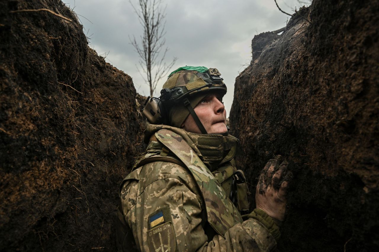 A Ukrainian serviceman takes cover in a trench near Bakhmut, Ukraine, during shelling on Wednesday, March 8.