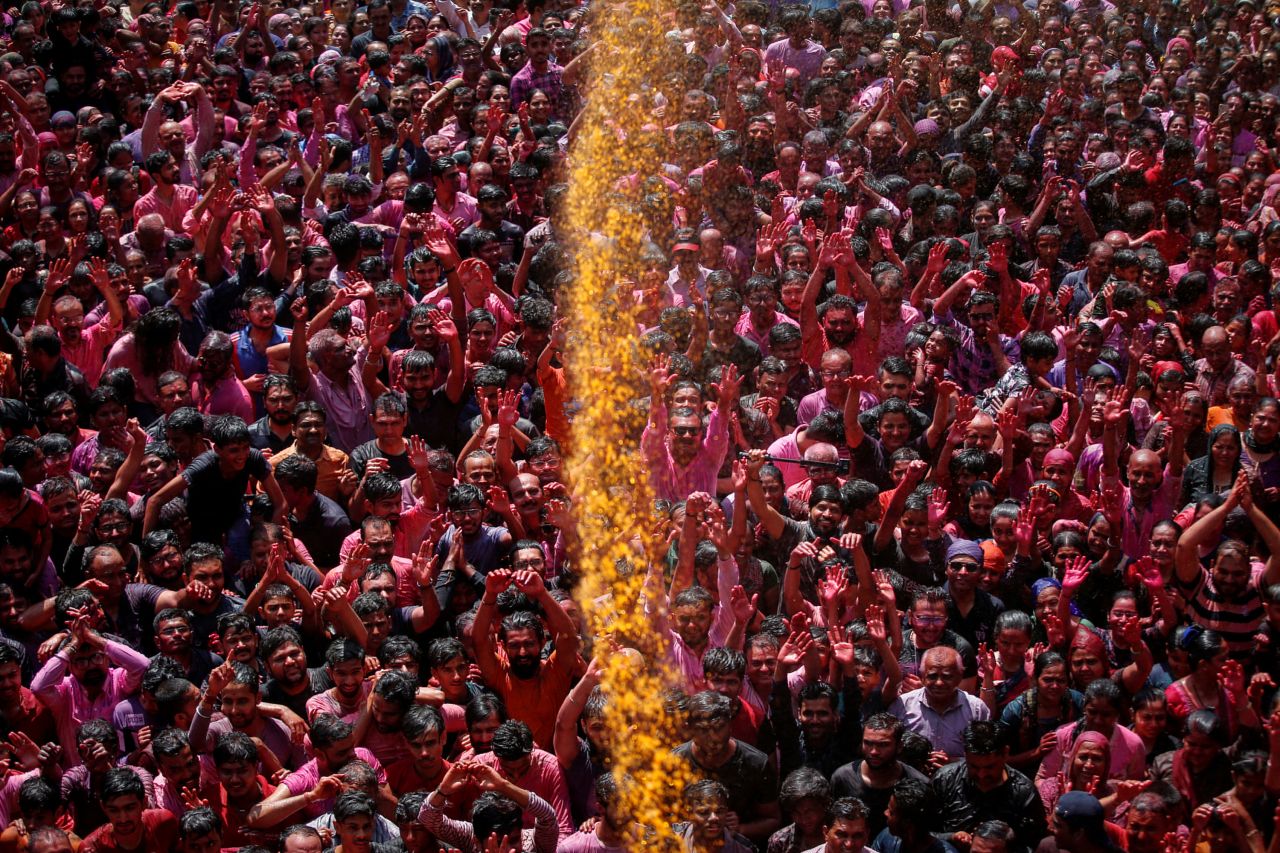 Hindu devotees are sprayed with colored water during Holi celebrations in Ahmedabad, India, on Wednesday, March 8. Millions of people in India and around the world <a href="https://www.cnn.com/2023/03/07/world/holi-2023-celebration-photos-cec/index.html" target="_blank">are celebrating Holi this week</a>. The Hindu festival of love, color and spring is one of the most joyous celebrations of the year.