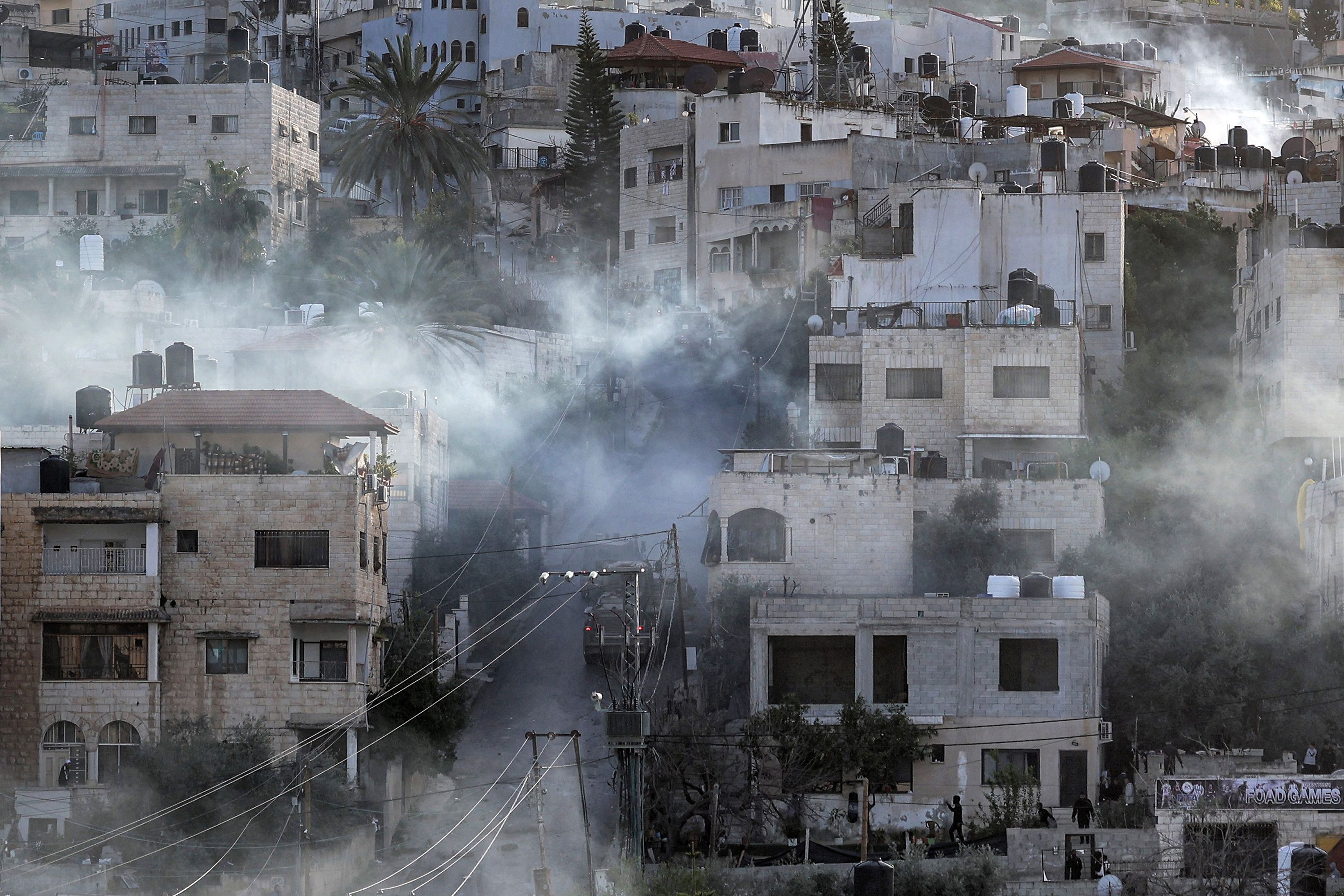 Israeli army vehicles move along a road into Jenin, in the occupied West Bank, on Tuesday, March 7.