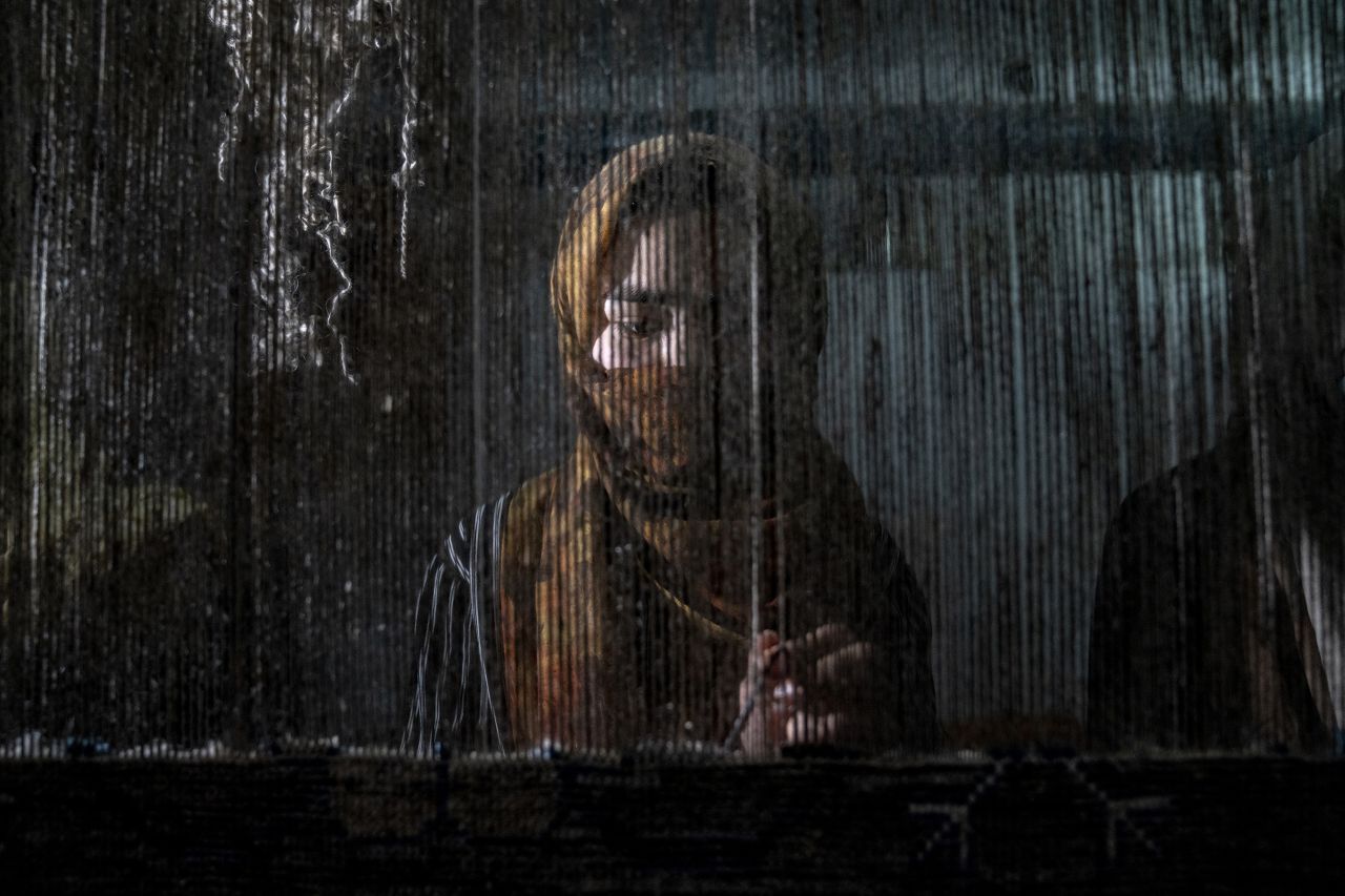 A woman weaves a carpet at a factory in Kabul, Afghanistan, on Monday, March 6. Since the Taliban took over the country in August 2021, <a href=