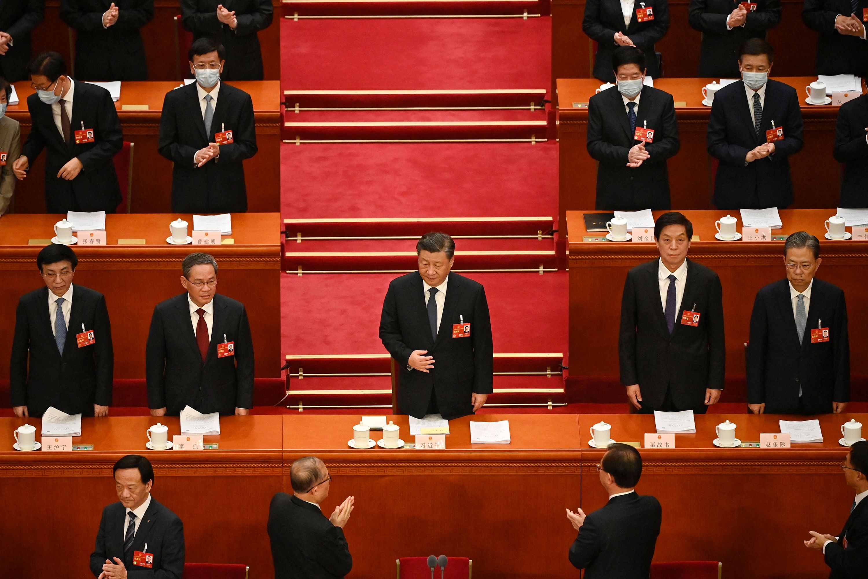 Chinese leader Xi Jinping, center, is applauded as he arrives for the second plenary session of the National's People Congress on Tuesday, March 7.