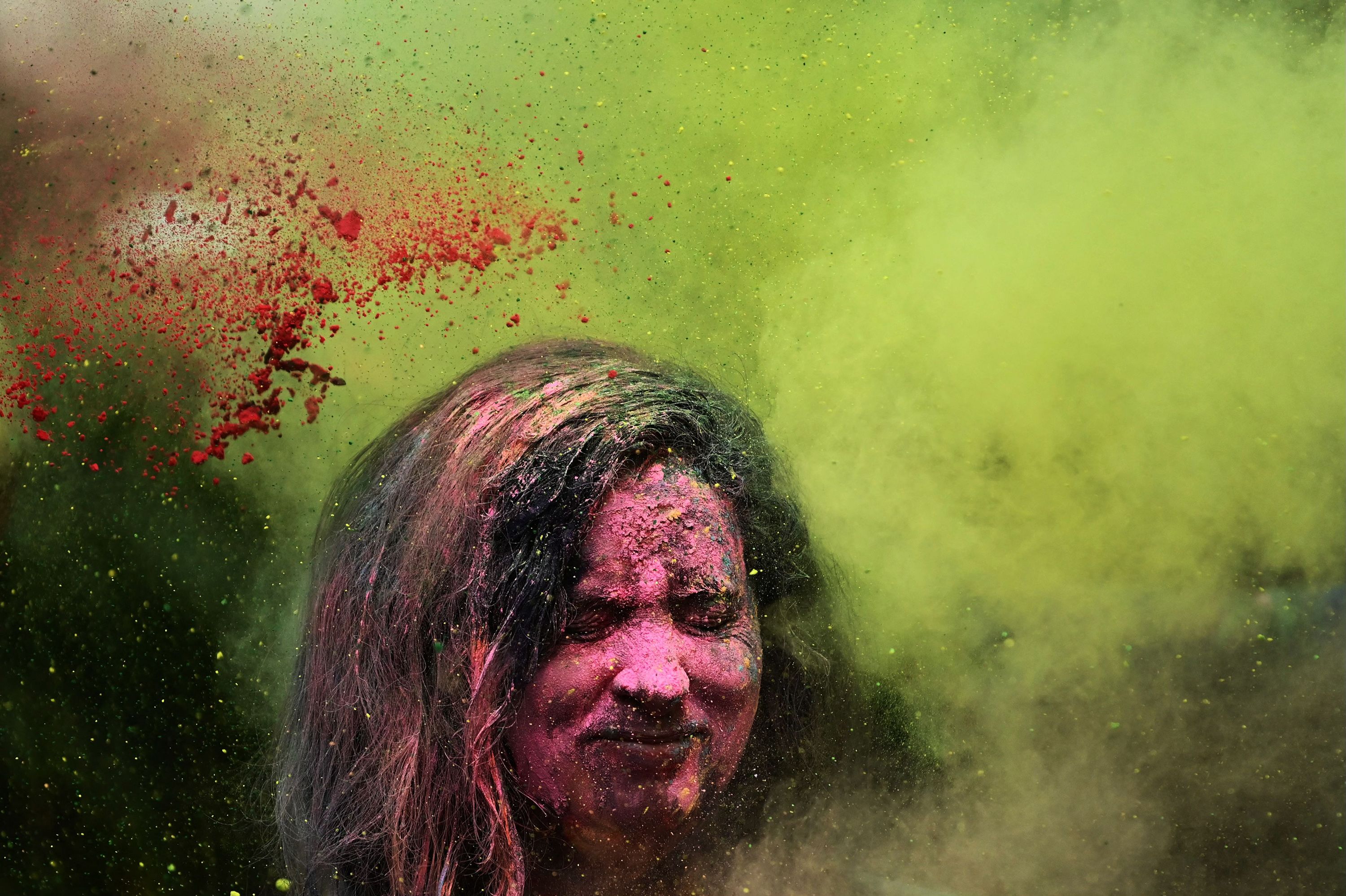 A Holi reveler is showered with colored powder during celebrations in Mumbai, India, on Tuesday, March 7.