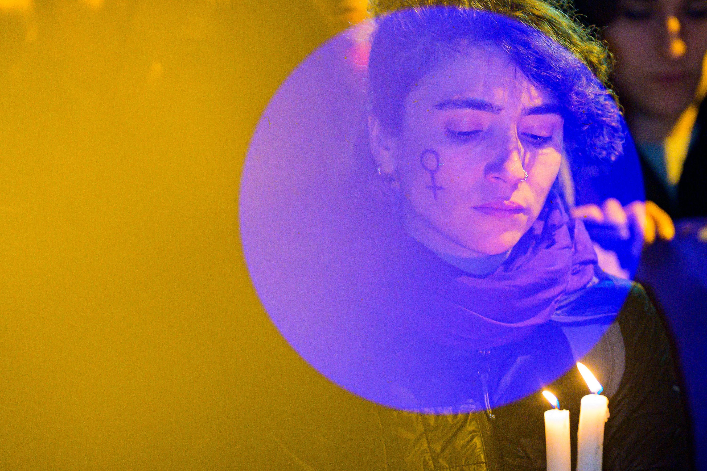 A woman holds candles during a march to Istanbul's Taksim Square to mark International Women's Day on Wednesday, March 8.