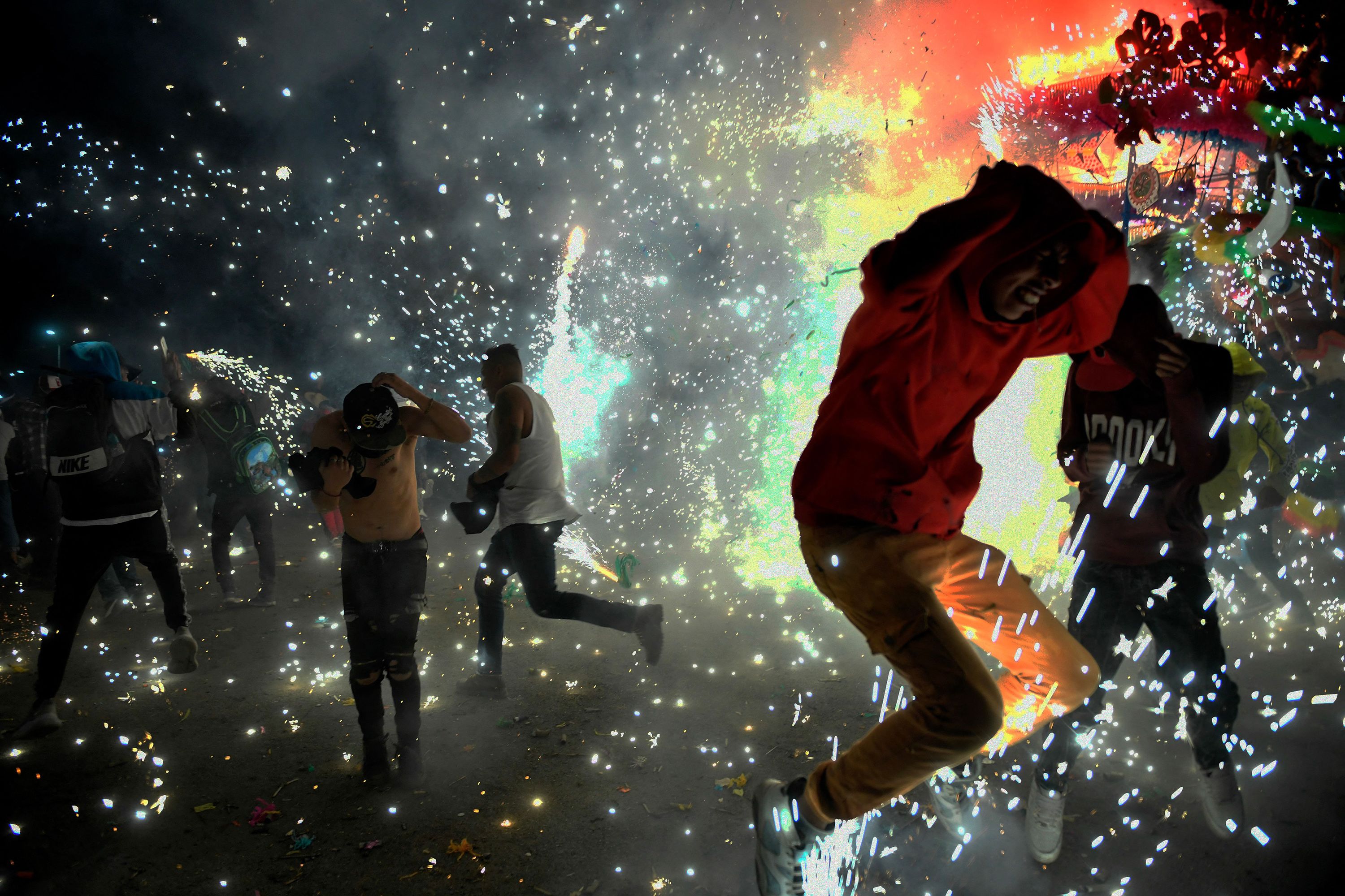 Fireworks explode from a bull figure frame during a San Juan de Dios celebration in Tultepec, Mexico, on Wednesday, March 8.