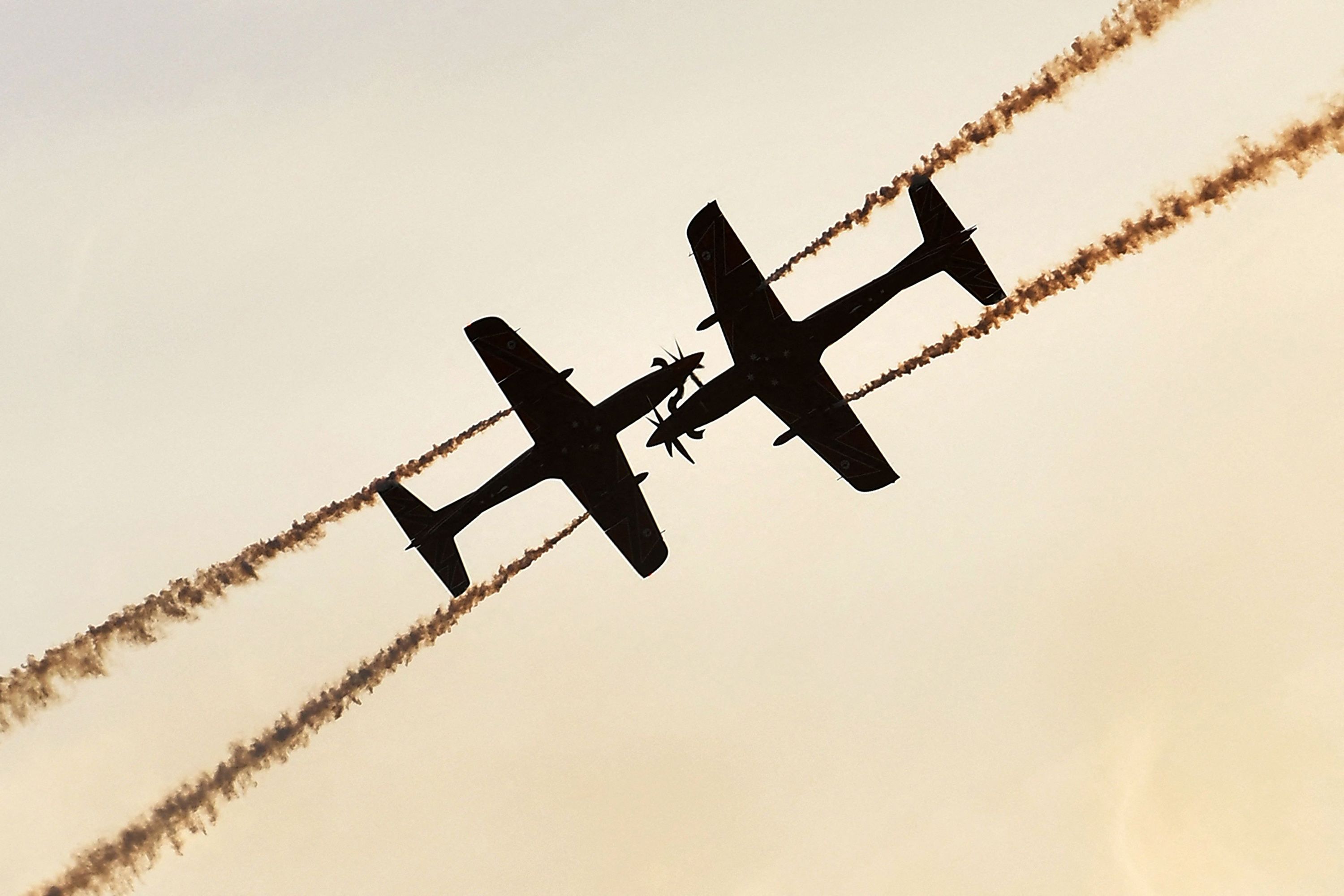 Two planes with the Roulettes, the Royal Australian Air Force's aerobatic display team, perform during an air show in Geelong, Australia, on Friday, March 3.