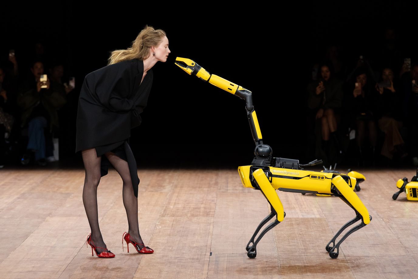 A model and a robot perform during a Coperni fashion show in Paris on Friday, March 3.