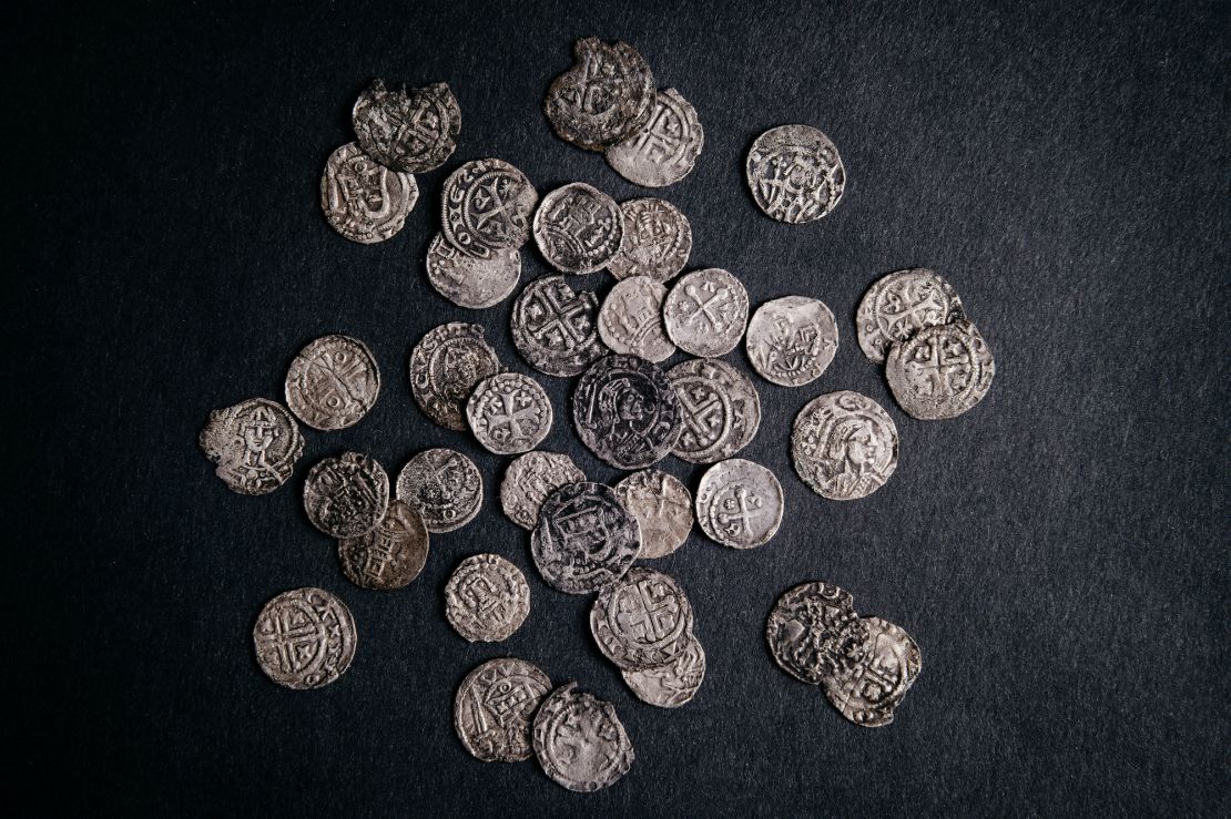 Part of the 1000-year-old medieval treasure discovered in Hoogwoud, Netherlands, consisting of jewelry and silver coins.