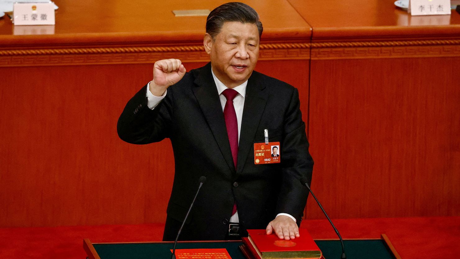Chinese leader Xi Jinping takes his oath while securing a historic third term as president, during a ceremonial vote in Beijing's Great Hall of the People on Friday.