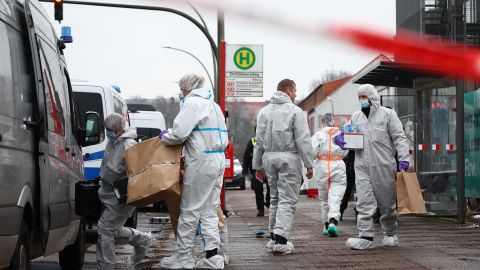 Forensics experts leave the Jehovah's Witnesses center in the Alsterdorf district of Hamburg on Friday morning.