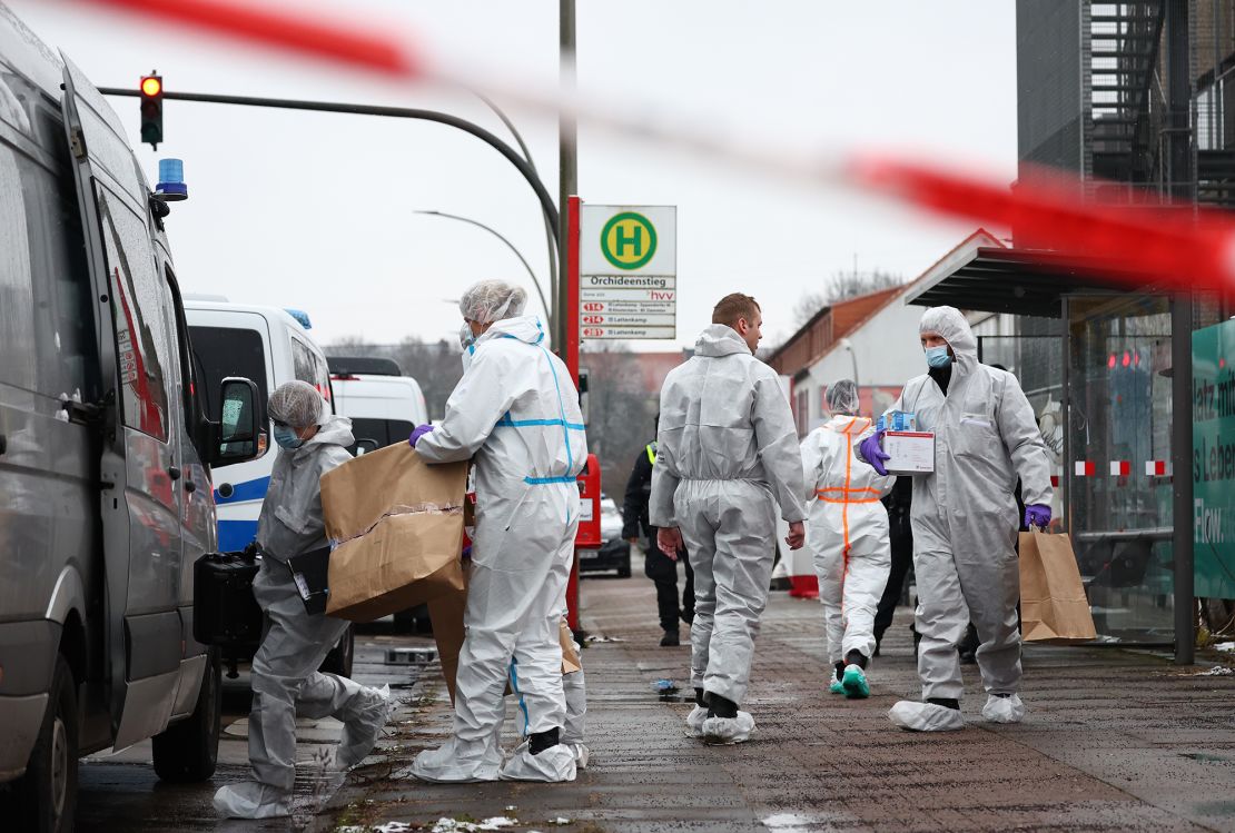 Forensics experts leave the Jehovah's Witnesses center in the Alsterdorf district of Hamburg on Friday morning.
