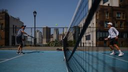People play pickleball at a public court in Brooklyn, New York on September 16, 2022. A game that's easy to pick up and more accessible than tennis, pickleball is all the rage in New York, as the sport snags investors and grows increasingly professionalized across the United States. 