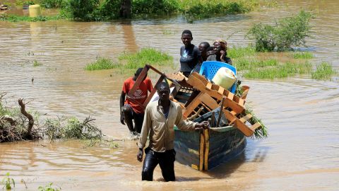 Residents used a boat to lug their belongings through floodwaters after their homes in Kenya were inundated by heavy rainfall and the backflow from Lake Victoria in May 3, 2020. 