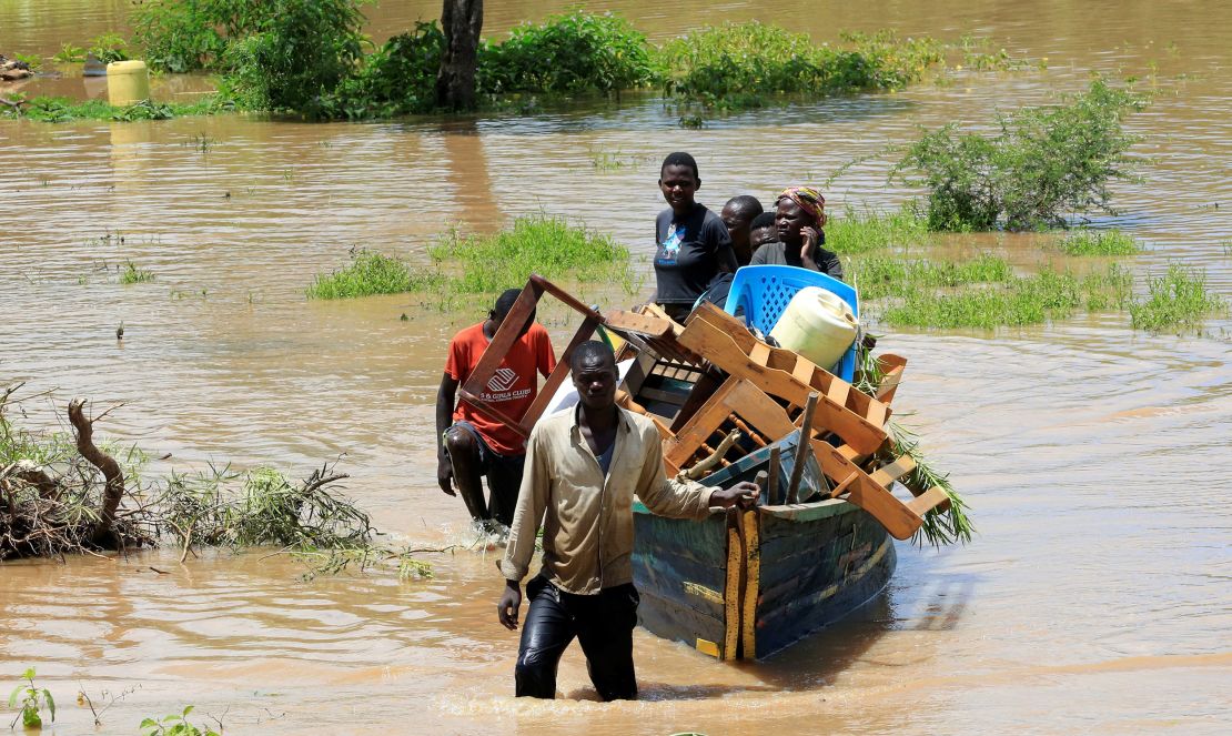 Residents used a boat to lug their belongings through floodwaters after their homes in Kenya were inundated by heavy rainfall and the backflow from Lake Victoria in May 3, 2020. 