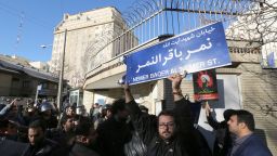 An Iranian protester holds a street sign bearing the name of prominent Shiite Muslim cleric Nimr al-Nimr during a demonstration against his execution by Saudi authorities, on January 3, 2016, outside the Saudi embassy in Tehran. 