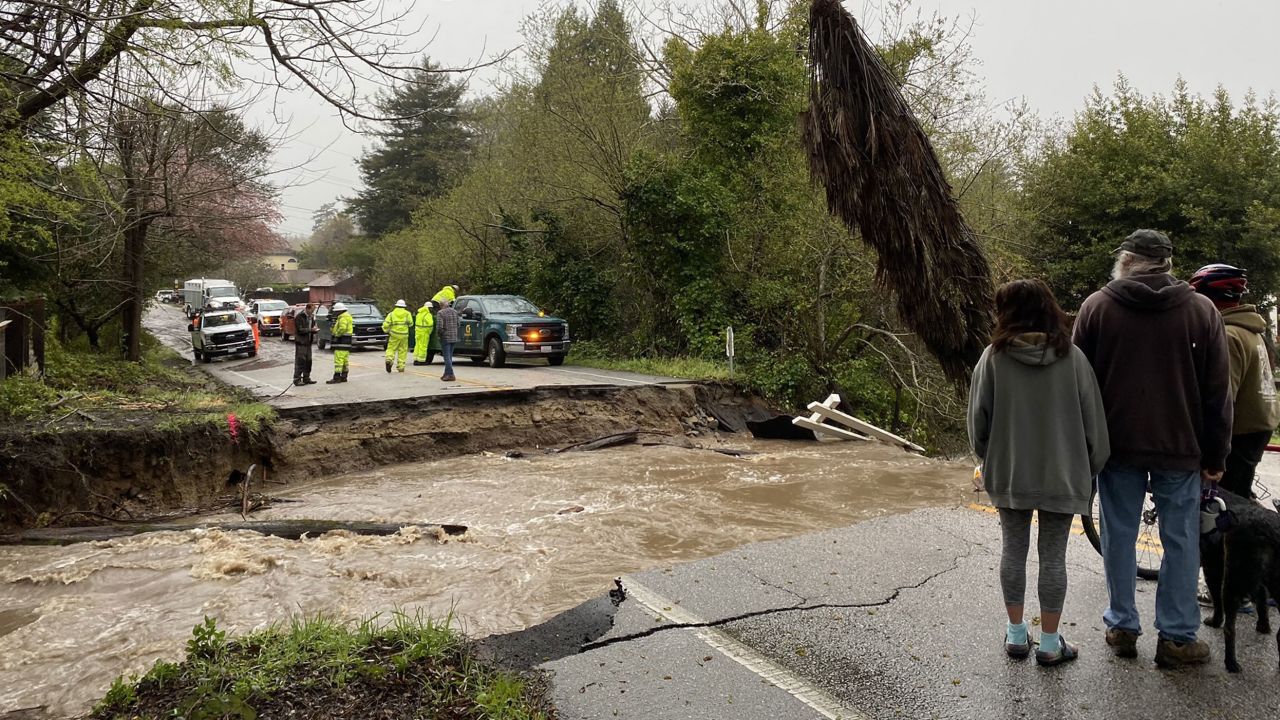 Residents of Soquel, California, are trapped after intense flooding caused the area's main road to collapse.