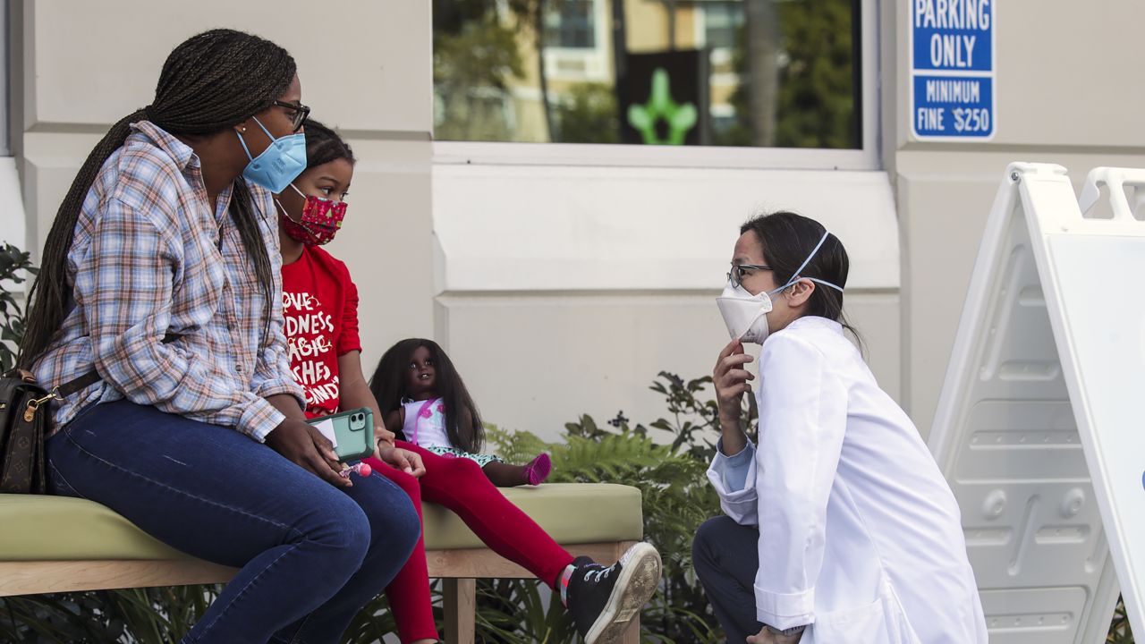 Dr. Susan Wu, right, chats with a child who got her first dose of the Pfizer-BioNtech Covid-19 vaccine at Children's Hospital Arcadia Speciality Care Center in Arcadia, California, in 2022.