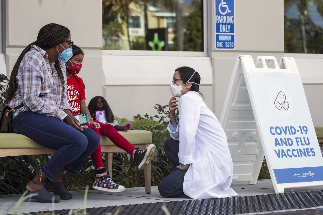 Dr. Susan Wu, right, chats with a child who got her first dose of the Pfizer-BioNtech Covid-19 vaccine at Children's Hospital Arcadia Speciality Care Center in Arcadia, California, in 2022.