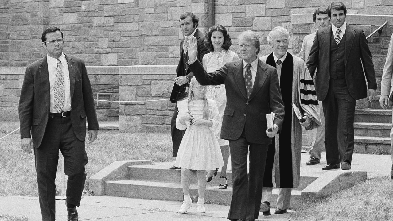 President Jimmy Carter waves as he departs the First Baptist Church in Washington with daughter Amy and daughter-in-law Caron Carter on June 9, 1977.