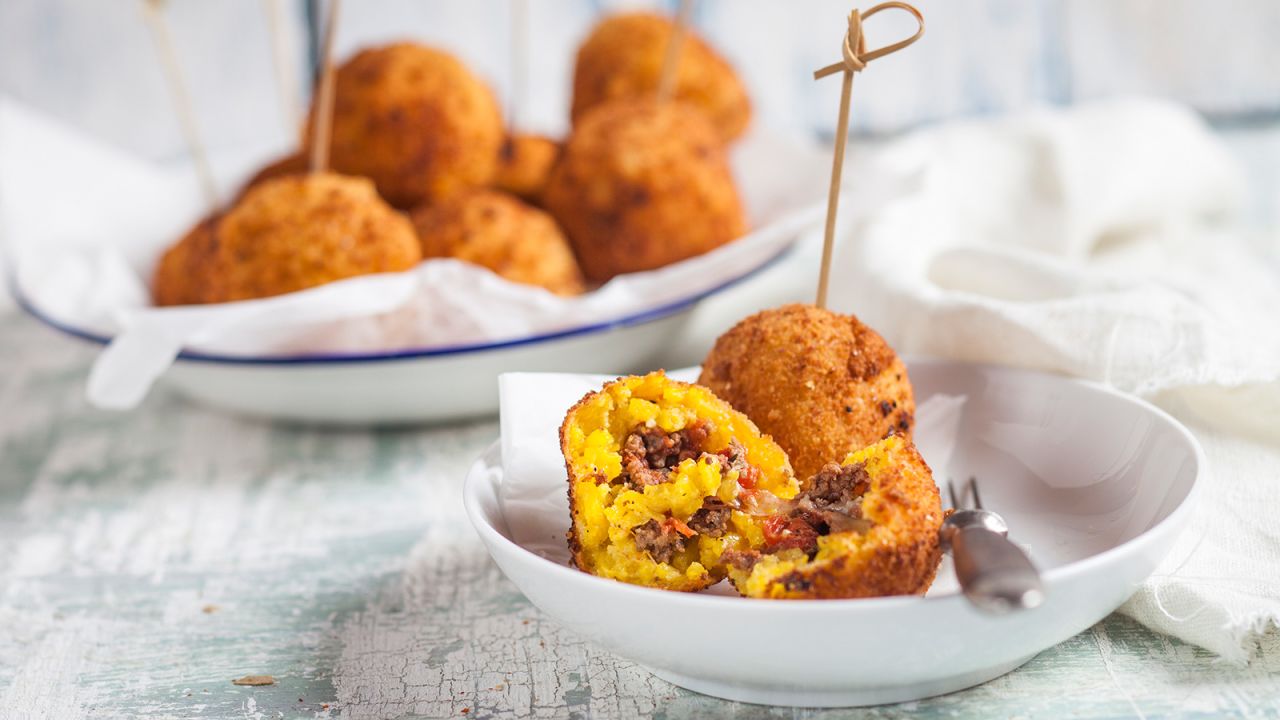Stuffed rice balls that are breaded and fried are a must-try street food in Sicily.