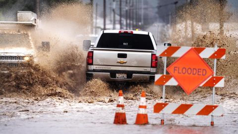 Mobil dan truk melewati jalan-jalan yang banjir di Salinas, California, pada 10 Maret.