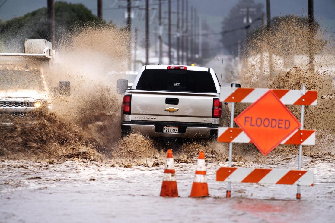 Cars and trucks drive through flooded streets in Salinas, California, on March 10.