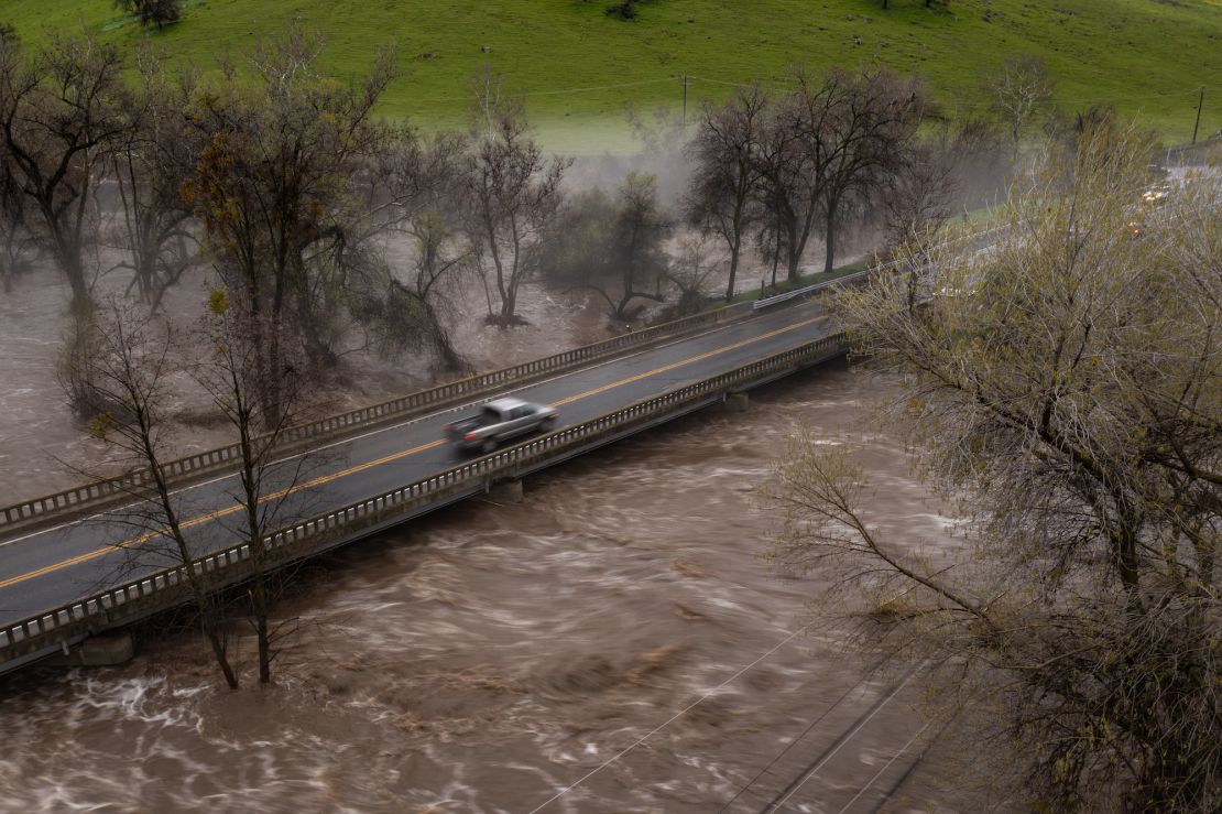 A pickup truck crosses a bridge over the flooding Tule River on March 10 near Springville, California. 