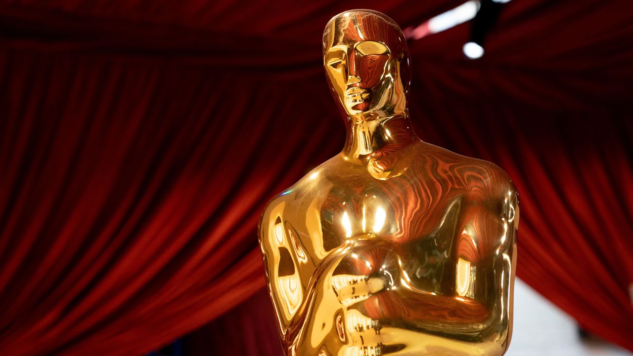 Oscars statues line the red carpet as preparations are made ahead of the 95th Academy Awards, in Hollywood, California, on March 10, 2023. - The red carpet for the Oscars airing on March 12, 2023, is champagne-color for 2023.