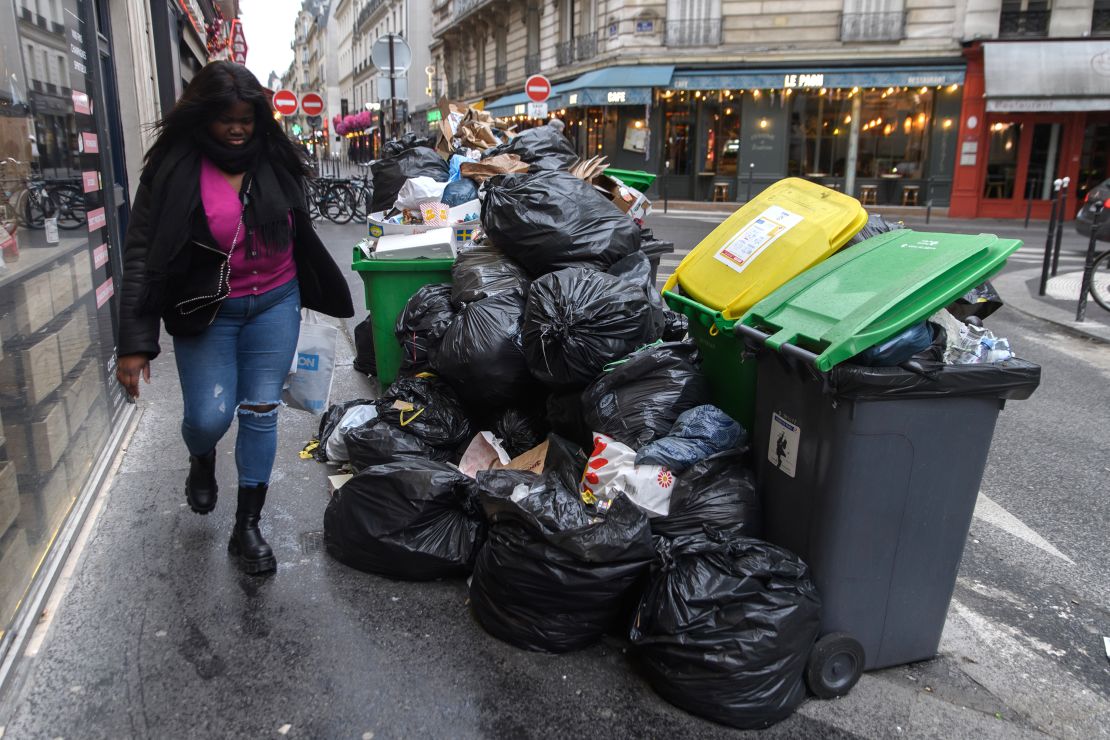 Rubbish bins are seen overflowing on the streets of Paris on Saturday. 