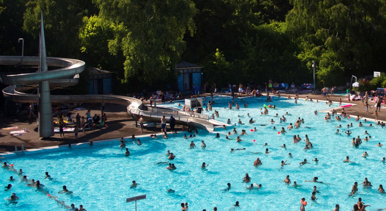 People swim in a public swimming pool in Berlin's Neukoelln district.
