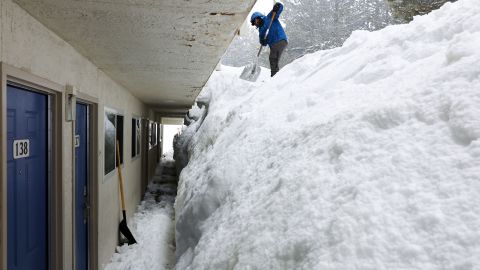 Cristian Nunez shovels a snowbank at a motel on March 11 in Mammoth Lakes, California.