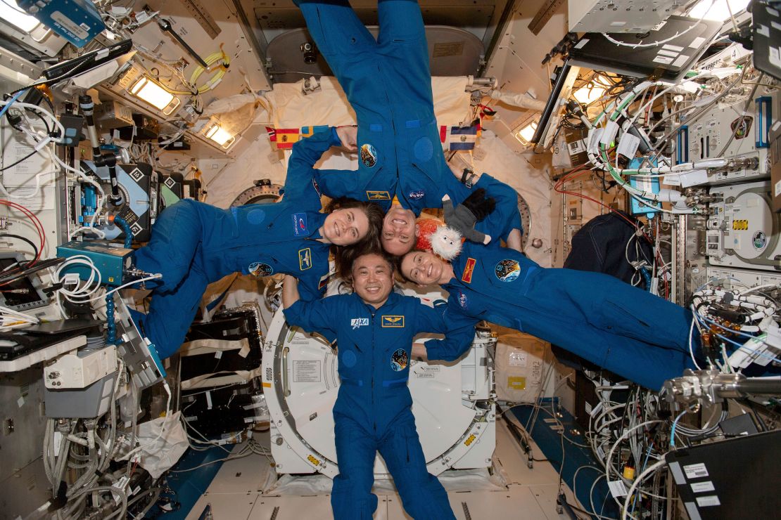 In this photo made available by NASA, clockwise from left, Expedition 68 Flight Engineers Anna Kikina of Roscosmos, Josh Cassada and Nicole Mann from NASA, and Koichi Wakata of JAXA (Japan Aerospace Exploration Agency) gather for a portrait inside the International Space Station's Kibo laboratory module on March 1, 2023.