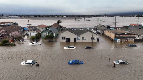 Cars and homes are engulfed by floodwaters in Pajaro, California, on Saturday.