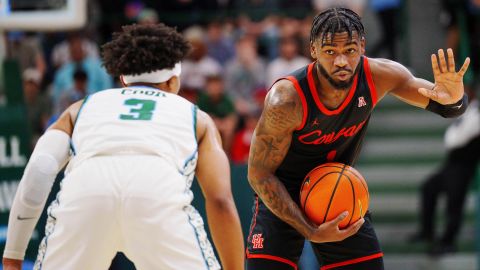 Houston Cougars guard Jamal Shead (1) signals to his team.