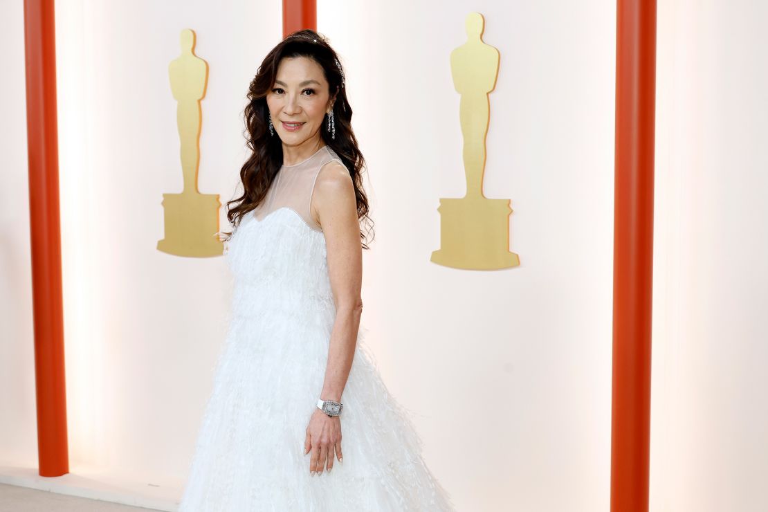 Best Actress nominee Michelle Yeoh turned heads in a dreamy white, floor-length dress by Dior, paired with diamond Moussaieff jewelry.  