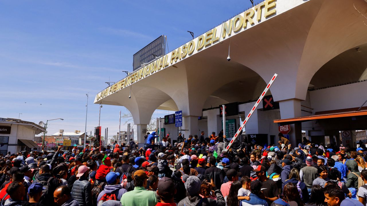 Migrants amassed at the Paso del Norte international bridge Sunday.