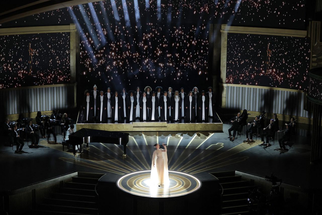 Sofia Carson sings the Oscar-nominated song "Applause" from "Tell It Like a Woman." Diane Warren is playing the piano.