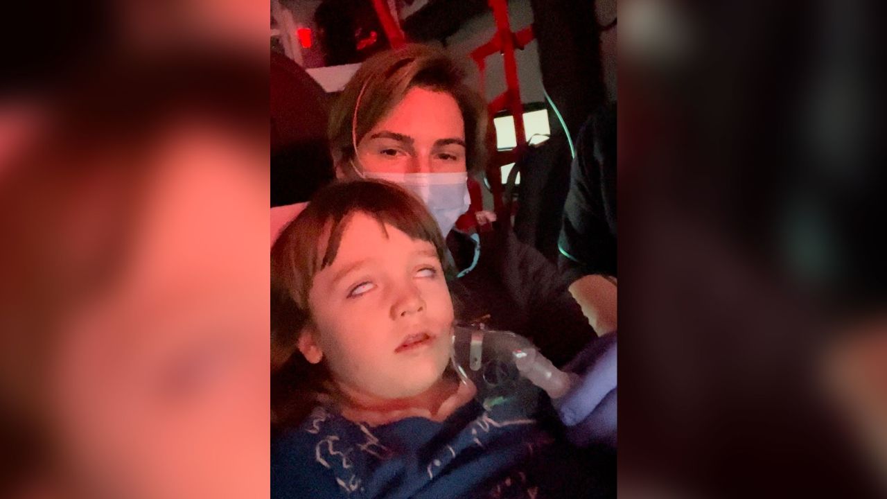 Mary Saladino holds her son, Henry, in an ambulance as they rush to the hospital following a violent seizure.