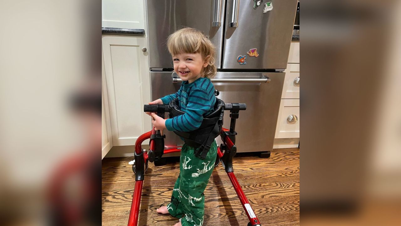 Henry Saladino is shown practicing how to walk using his walker.