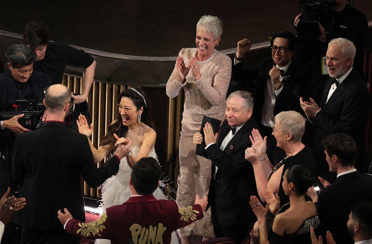 Daniel Scheinert, left, celebrates with Yeoh after he and Daniel Kwan, bottom, <a href=