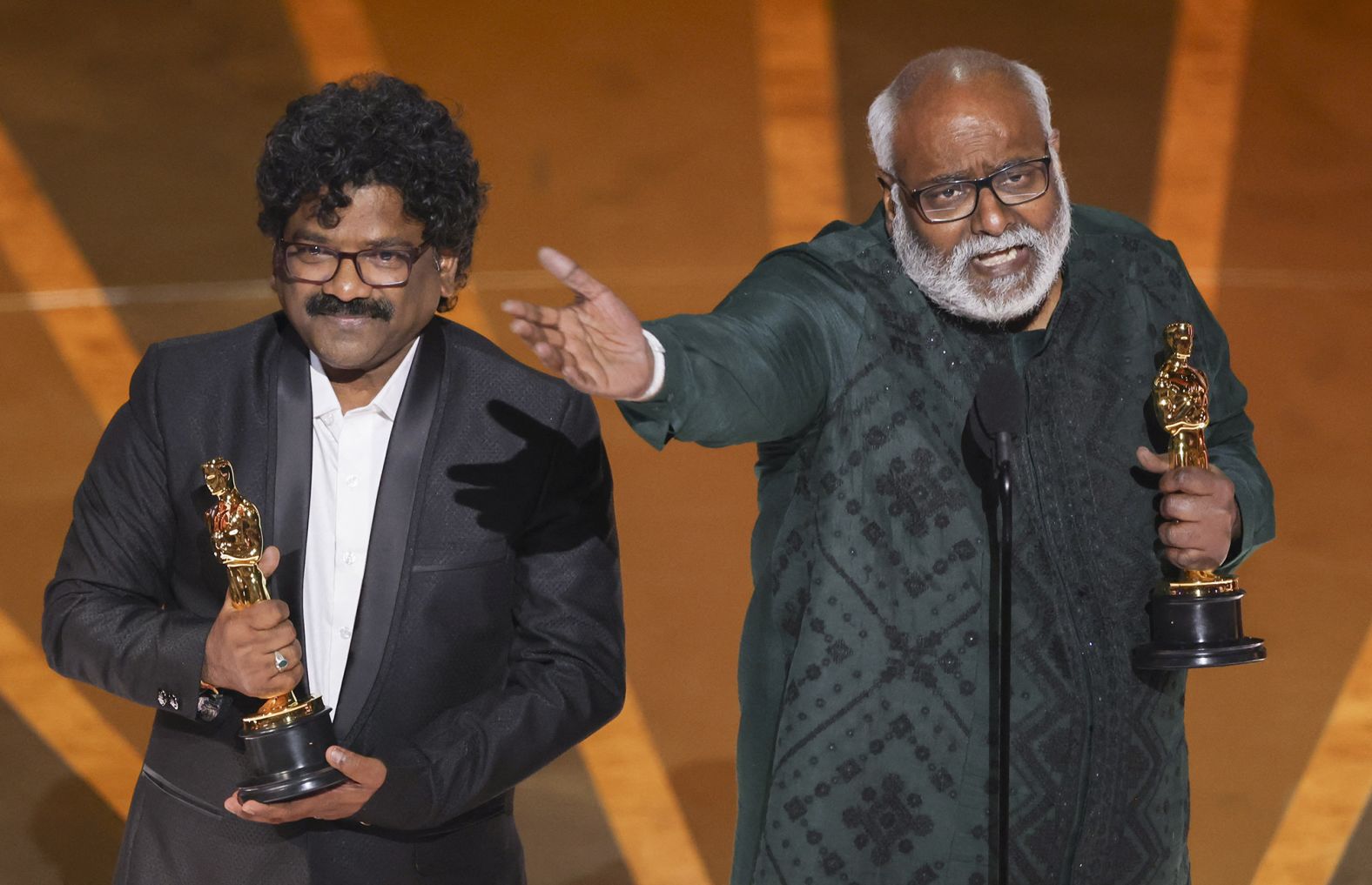 Chandrabose, left, and M.M. Keeravaani accept the Oscar for best original song  ("Naatu Naatu" from the film "RRR"). Keeravaani wrote the music, while Chandrabose wrote the lyrics. "I grew up listening to The Carpenters and now here I am with the Oscars," Keeravaani said before going on to <a href="index.php?page=&url=https%3A%2F%2Fwww.cnn.com%2Fentertainment%2Flive-news%2Foscars-2023%2Fh_2452ff1a00c4f0c8ab0149cf89ffbfc8" target="_blank">sing his speech</a> to the tune of "Top of the World" by The Carpenters. "Naatu Naatu" is the first song from an Indian film to be nominated for an Oscar.