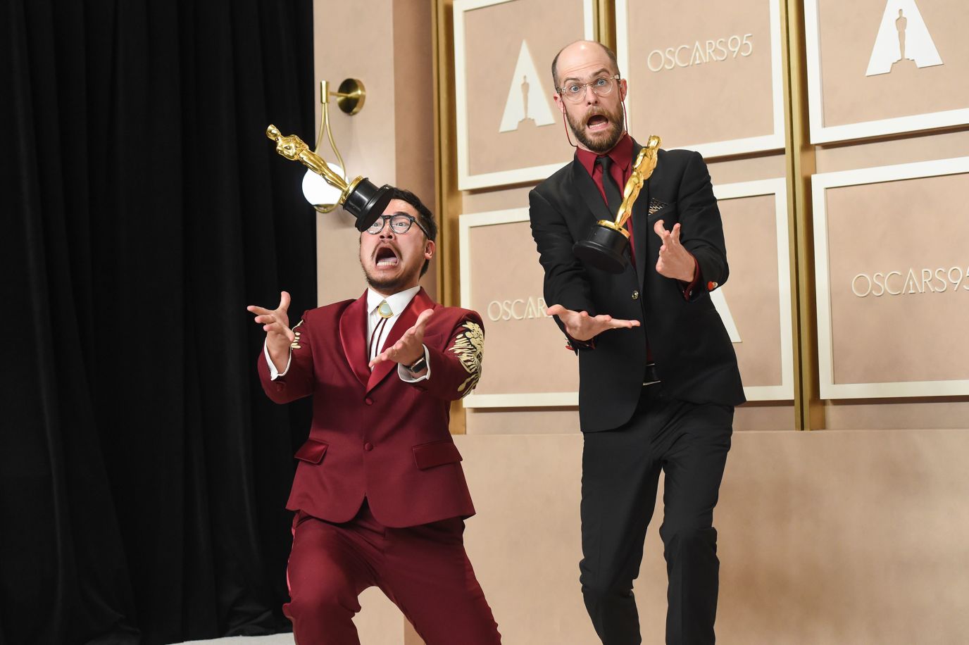 Kwan, left, and Scheinert have fun with some of their Oscars as they meet with the press.