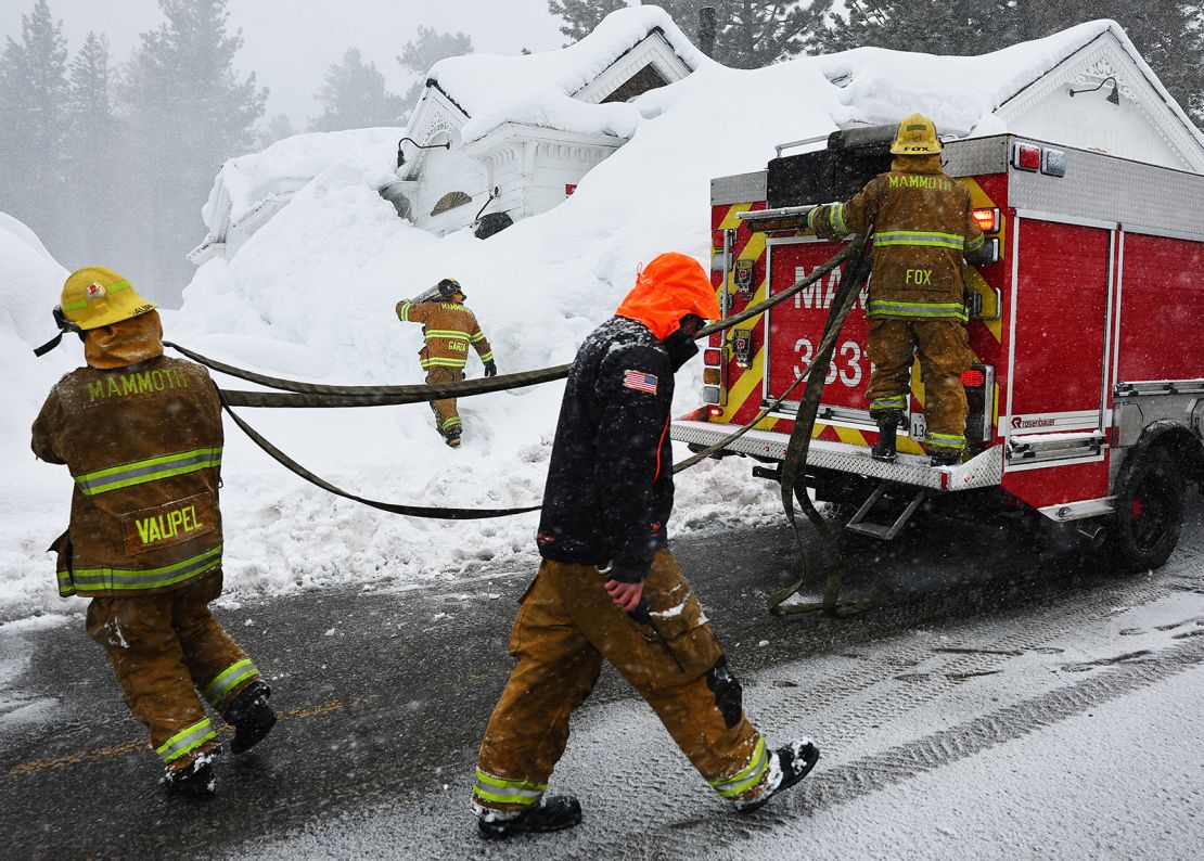 Mammoth Lakes firefighters respond to a propane heater leak and small fire at a shuttered restaurant surrounded by snowbanks Sunday.